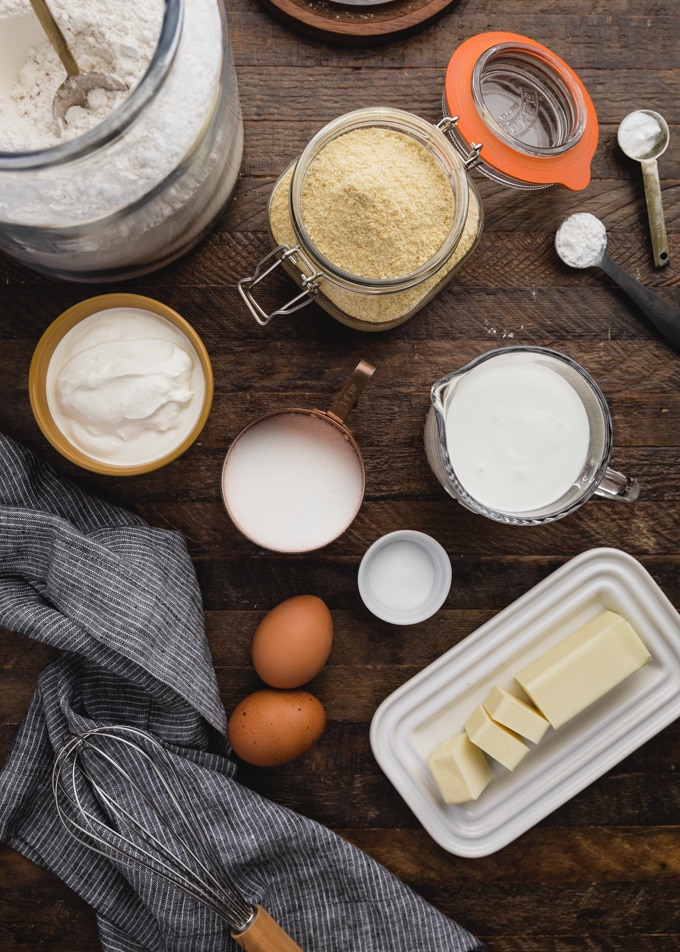 ingredients for making buttermilk cornbread measured out on a wood board