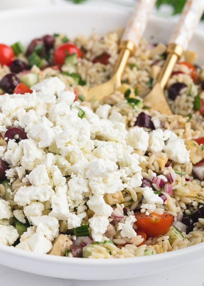 closeup of crumbled Greek Feta in a bowl of pasta salad