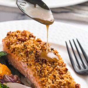 drizzling maple bourbon glaze over salmon