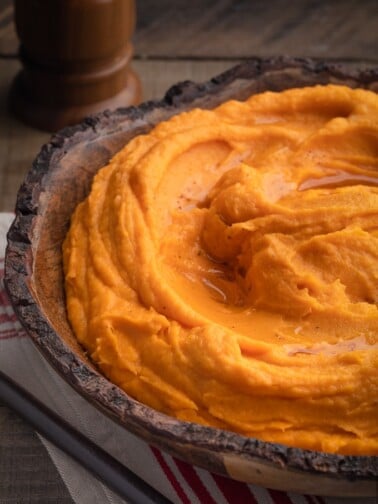 brown butter whipped sweet potatoes in a wood serving bowl