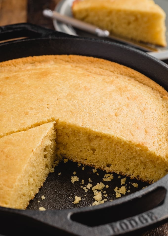 side view of baked sweet cornbread in a cast iron skillet