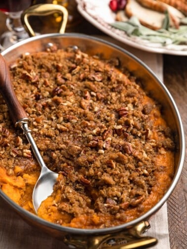 sweet potato casserole with pecan streusel topping in a copper gratin dish