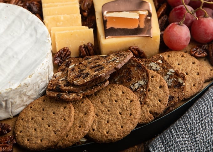 whole wheat crackers and raincoast crisps on a cheese board