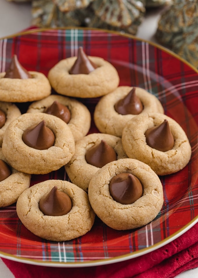 closeup of peanut blossom cookies on a red plaid Christmas plate