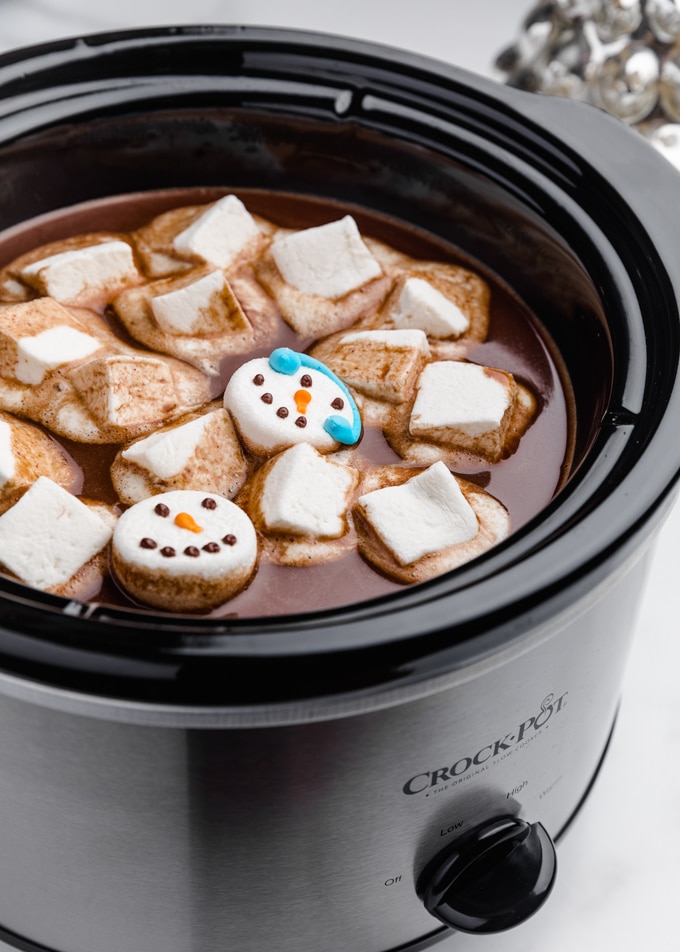 hot chocolate in a slow cooker with melted marshmallows on top