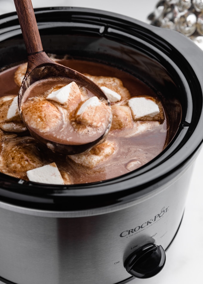 ladleful of slow cooker hot chocolate with melted marshmallows