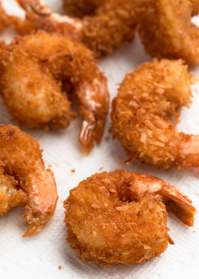 deep-fried coconut shrimp draining on paper towels