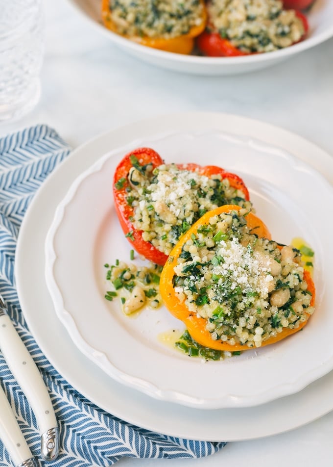 pearled couscous stuffed peppers served on a white plate