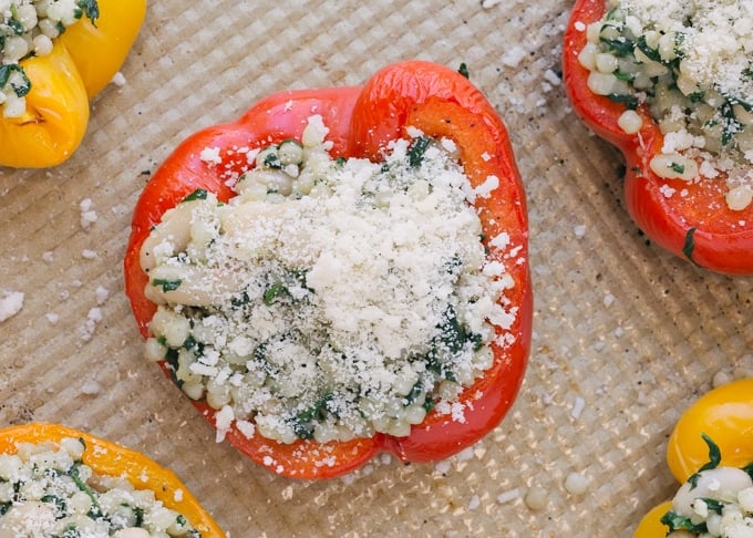 overhead view of unbaked vegetarian stuffed peppers on a baking sheet