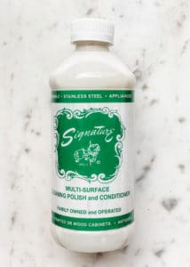 bottle of signature polish on a white marble board