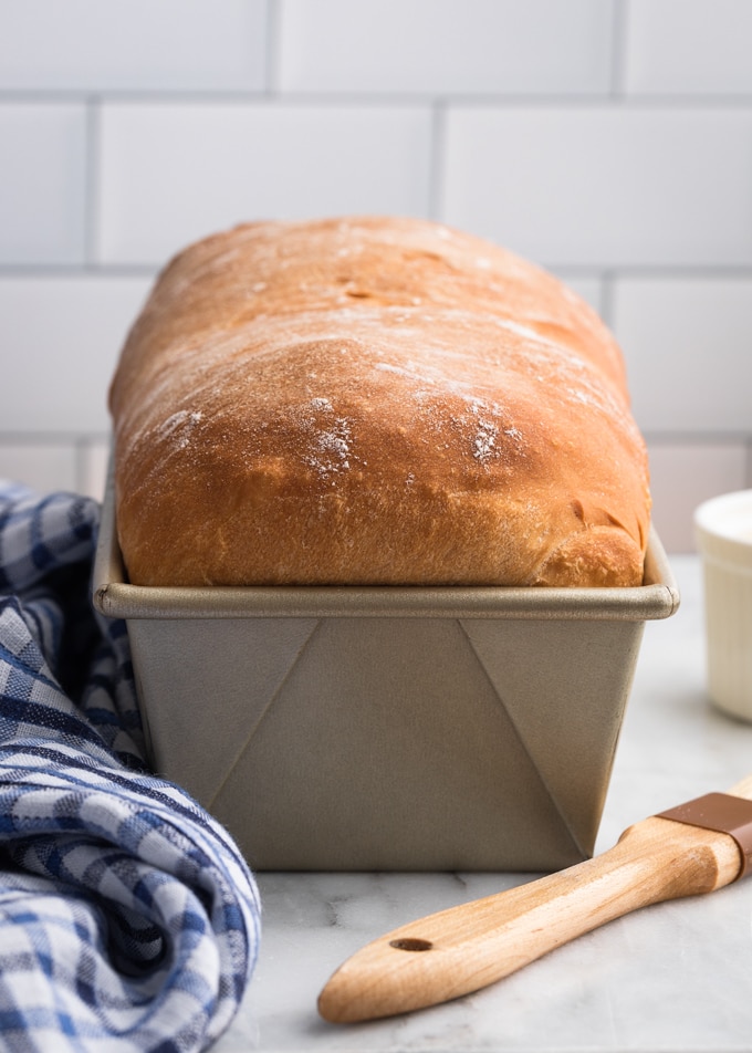 freshly-baked white bread in a loaf pan