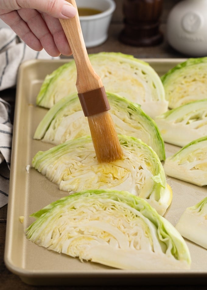 brushing green cabbage wedges with olive oil