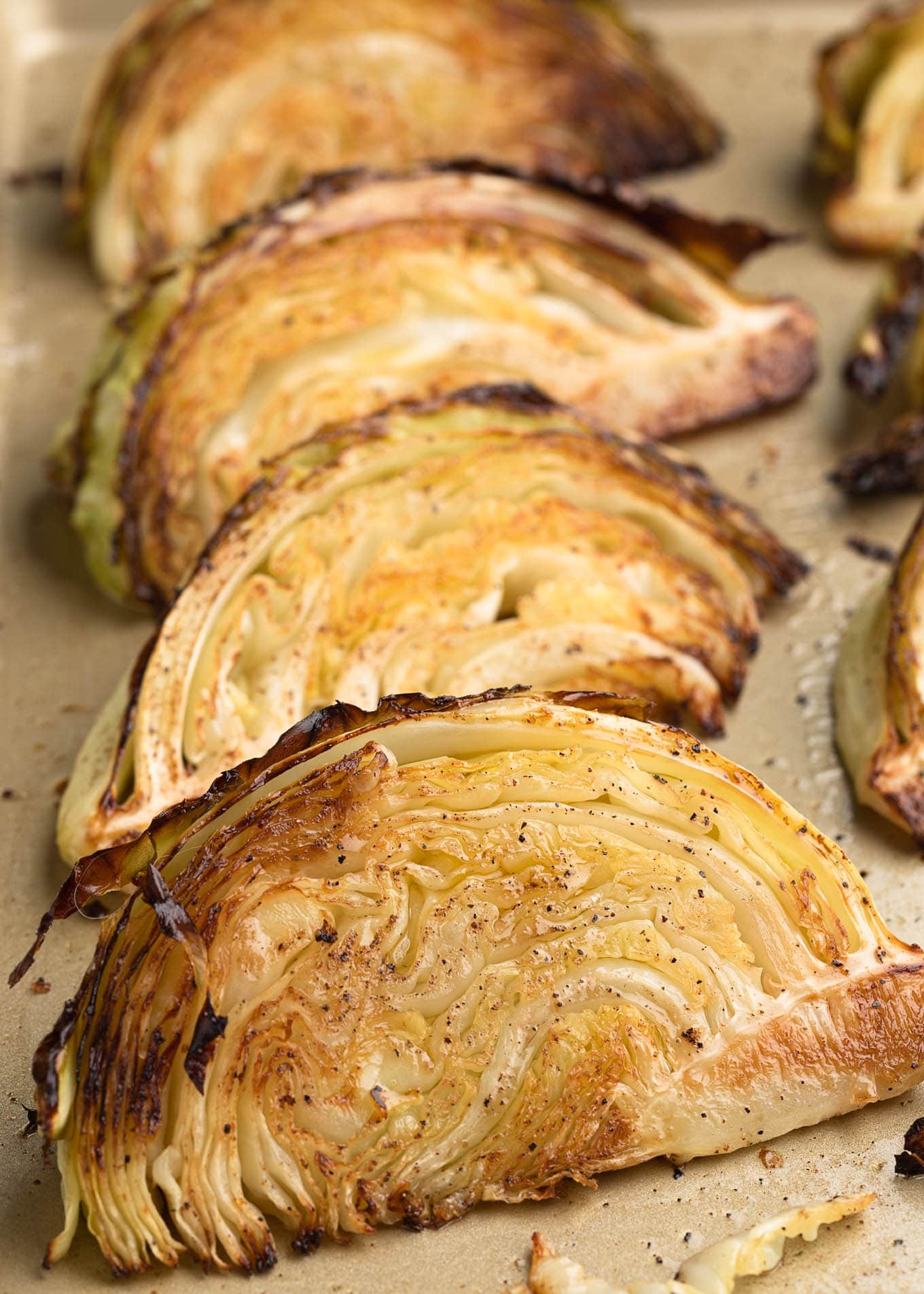 caramelized cabbage wedges on a baking sheet