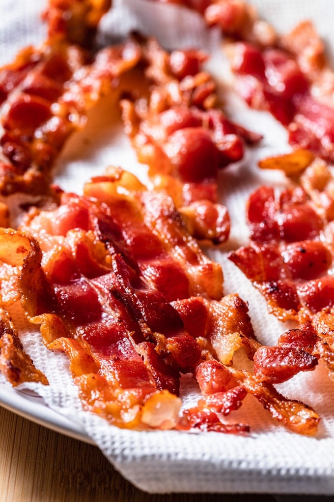 crisp cooked bacon on a paper towel lined plate