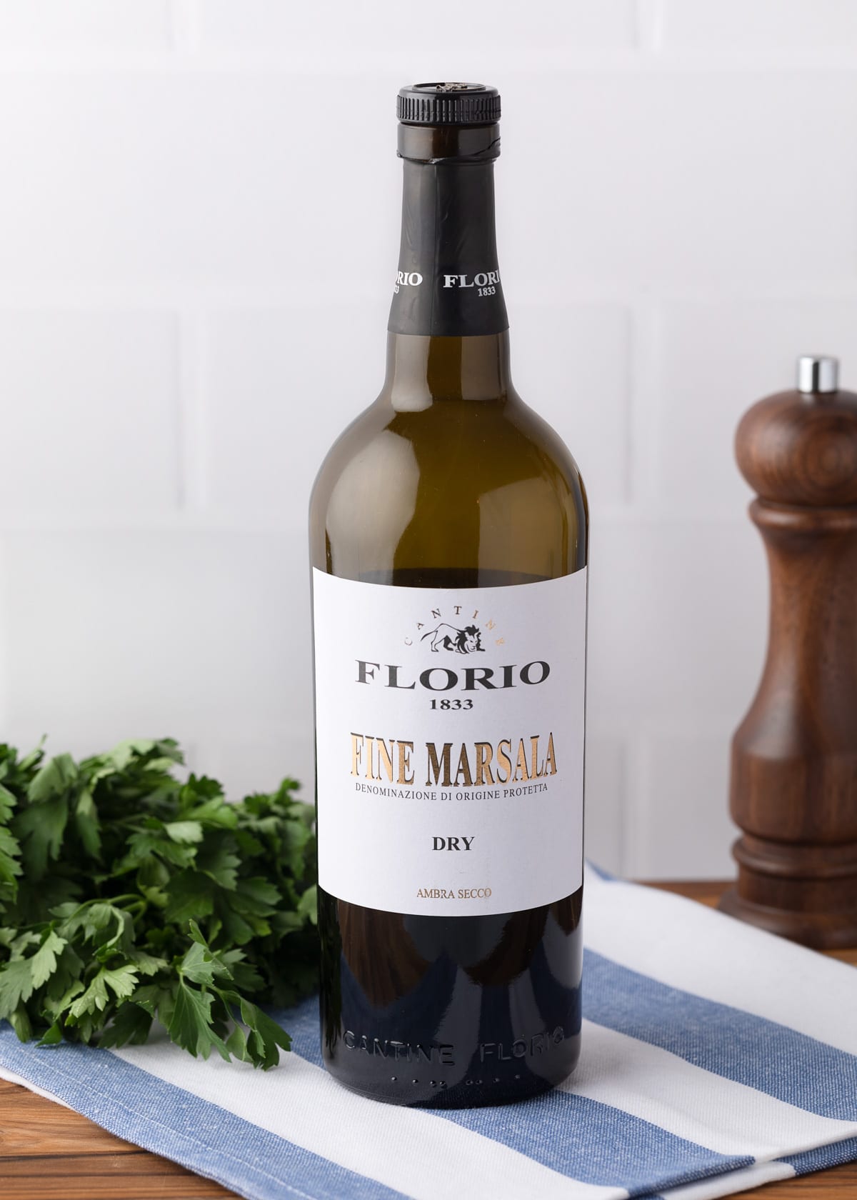 bottle of Florio dry marsala on a blue and white striped napkin 