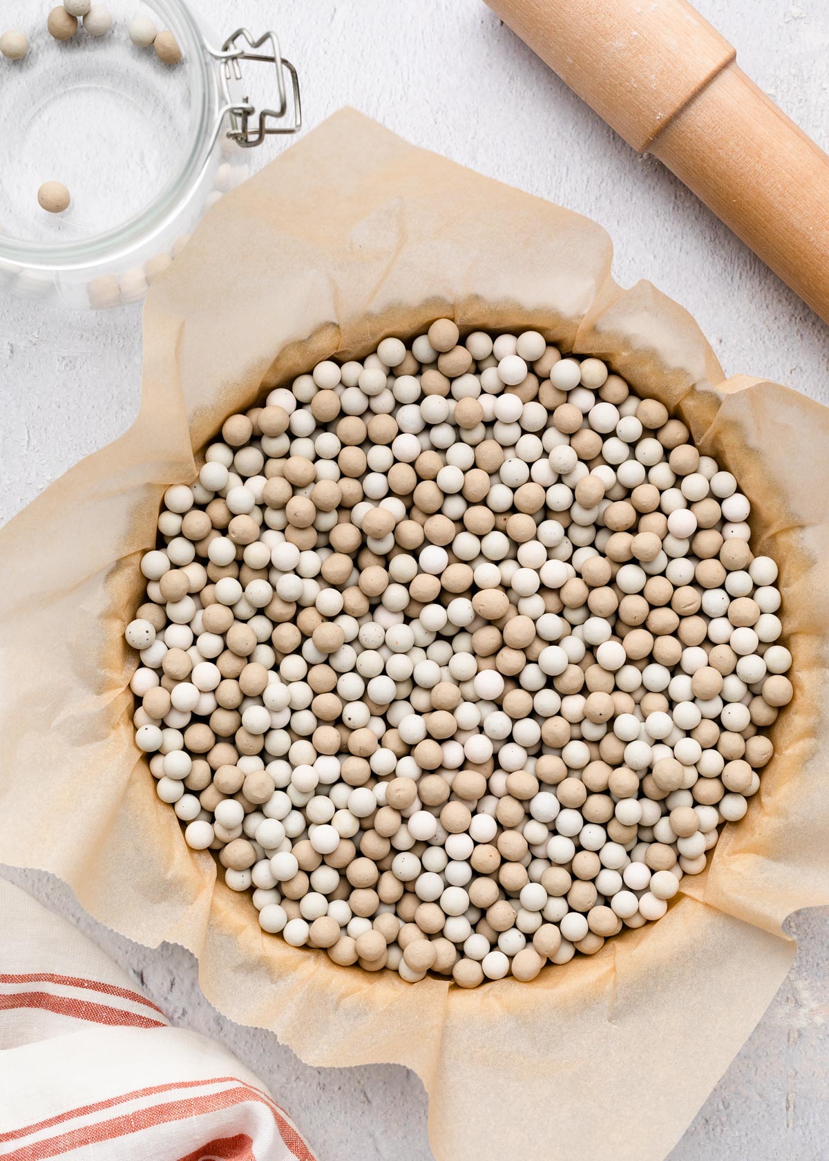 tart pan lined with parchment paper and filled with pie weights