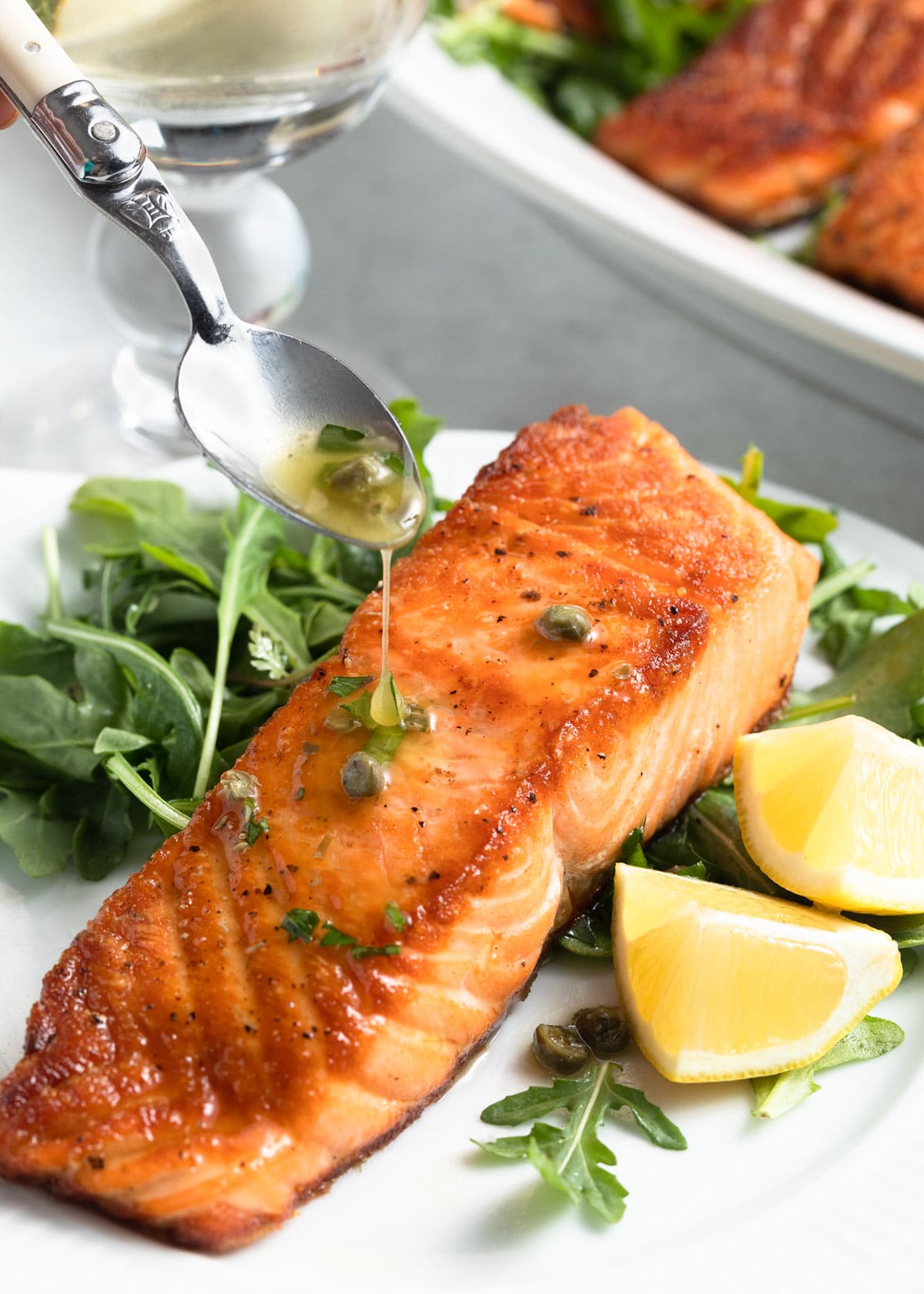 pan seared salmon fillet drizzled with lemon caper sauce