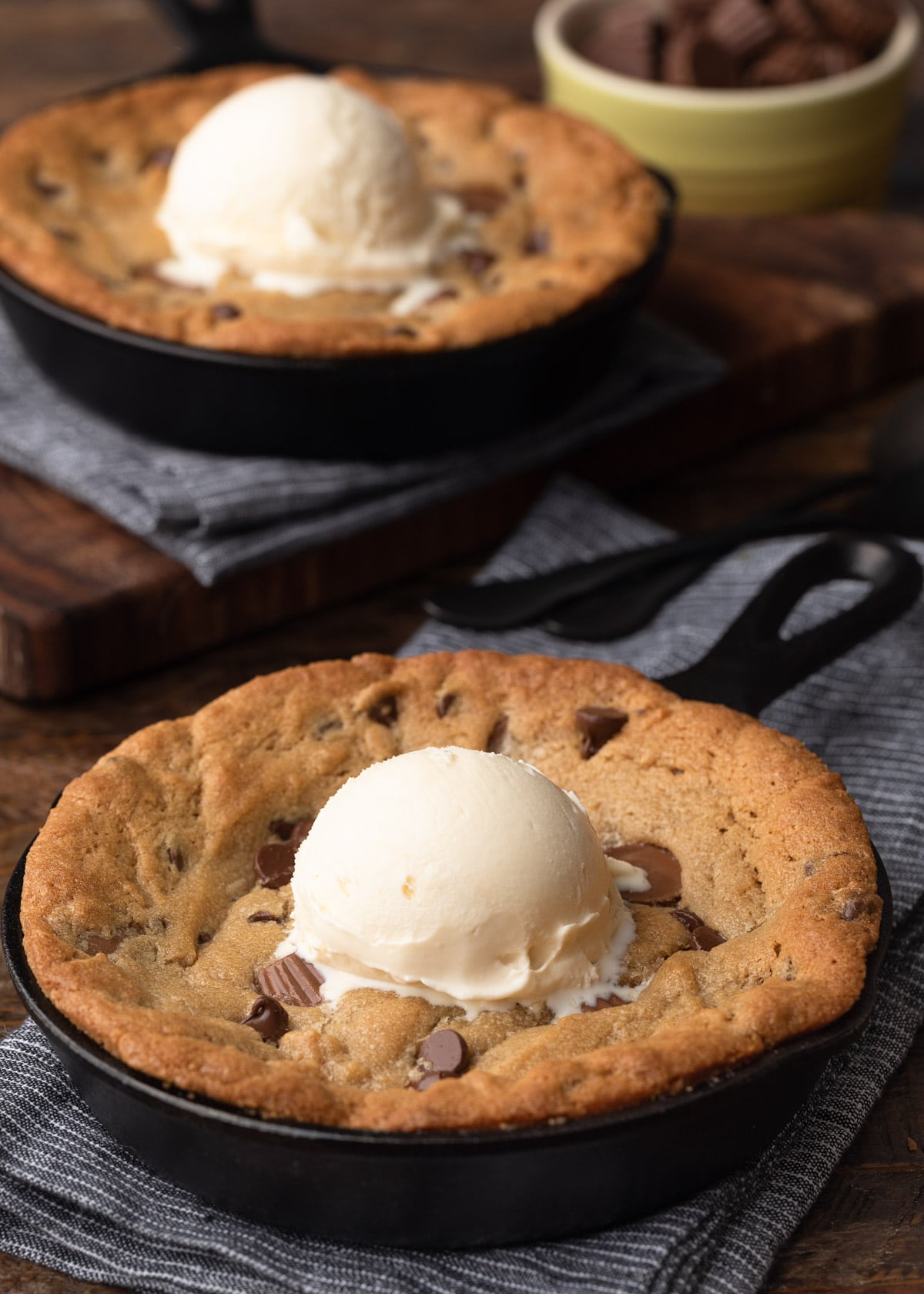 baked peanut butter skillet cookies with scoops of vanilla ice cream