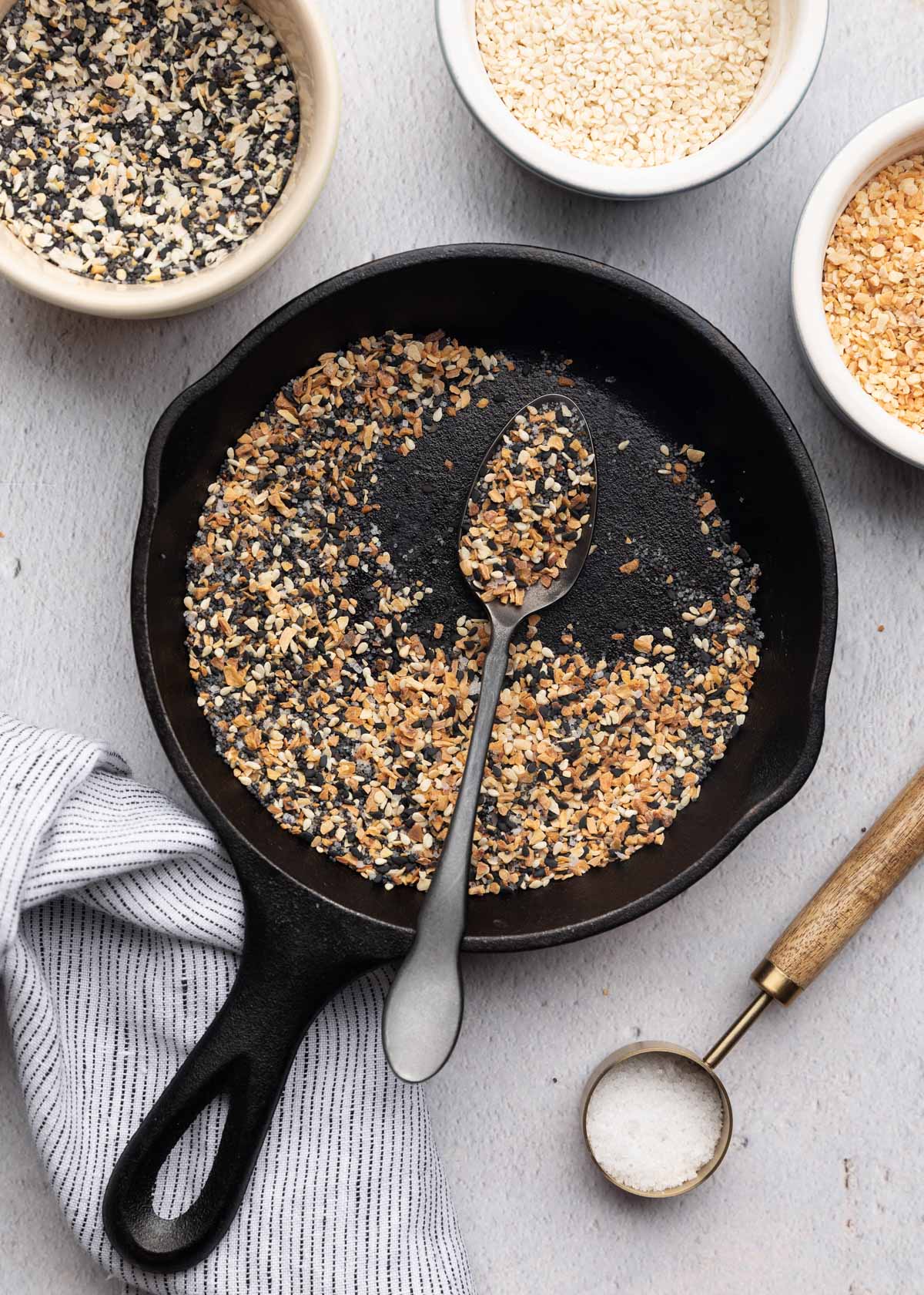 toasted everything spice in a cast iron skillet with a black spoon