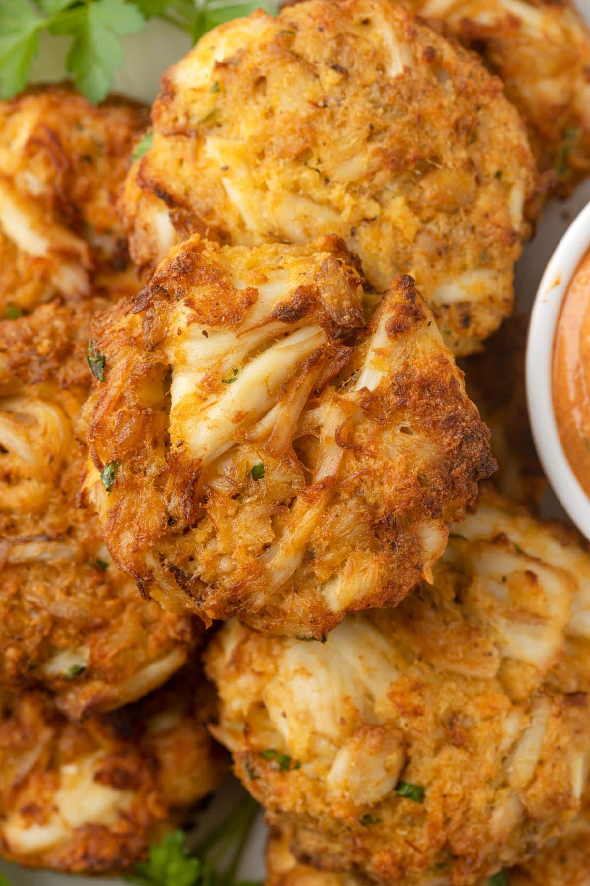 closeup of air fried crab cakes stacked on a serving plate