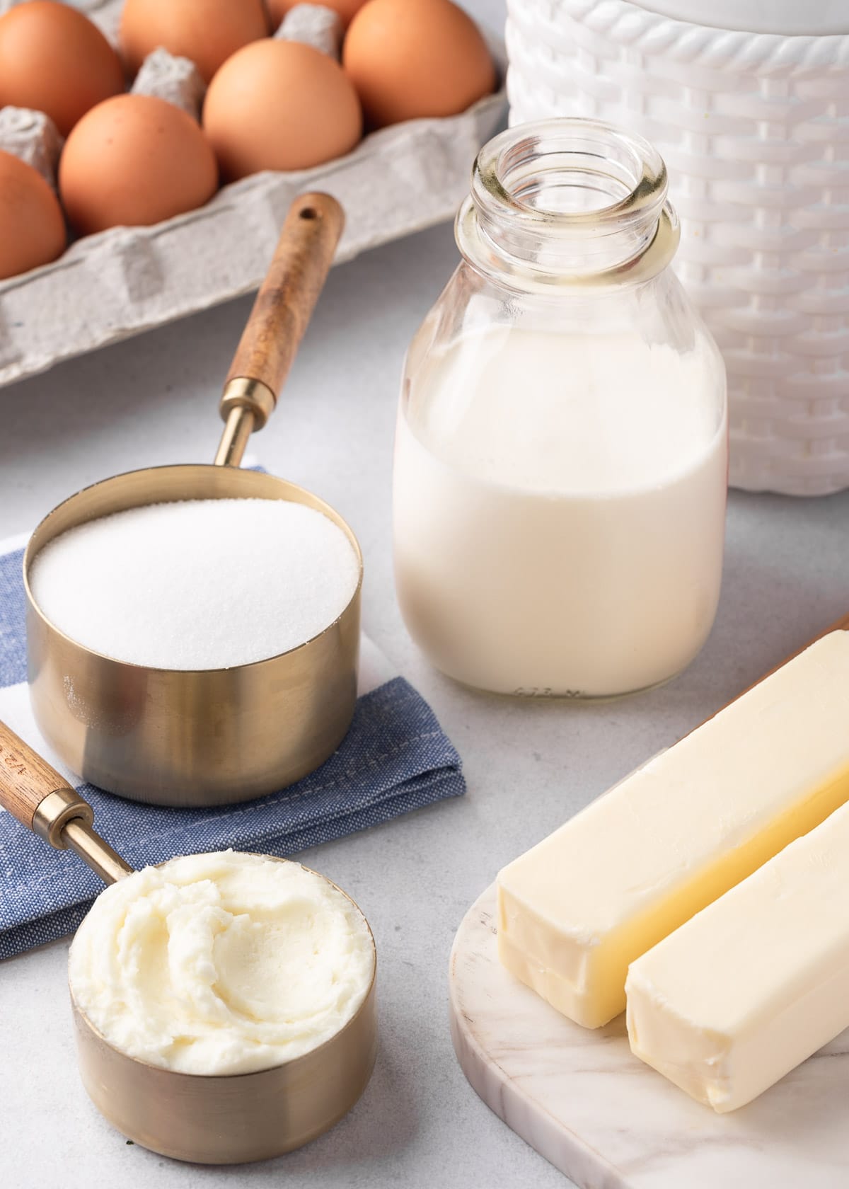 ingredients for vanilla pound cake: eggs, half and half, sugar, shortening, and butter