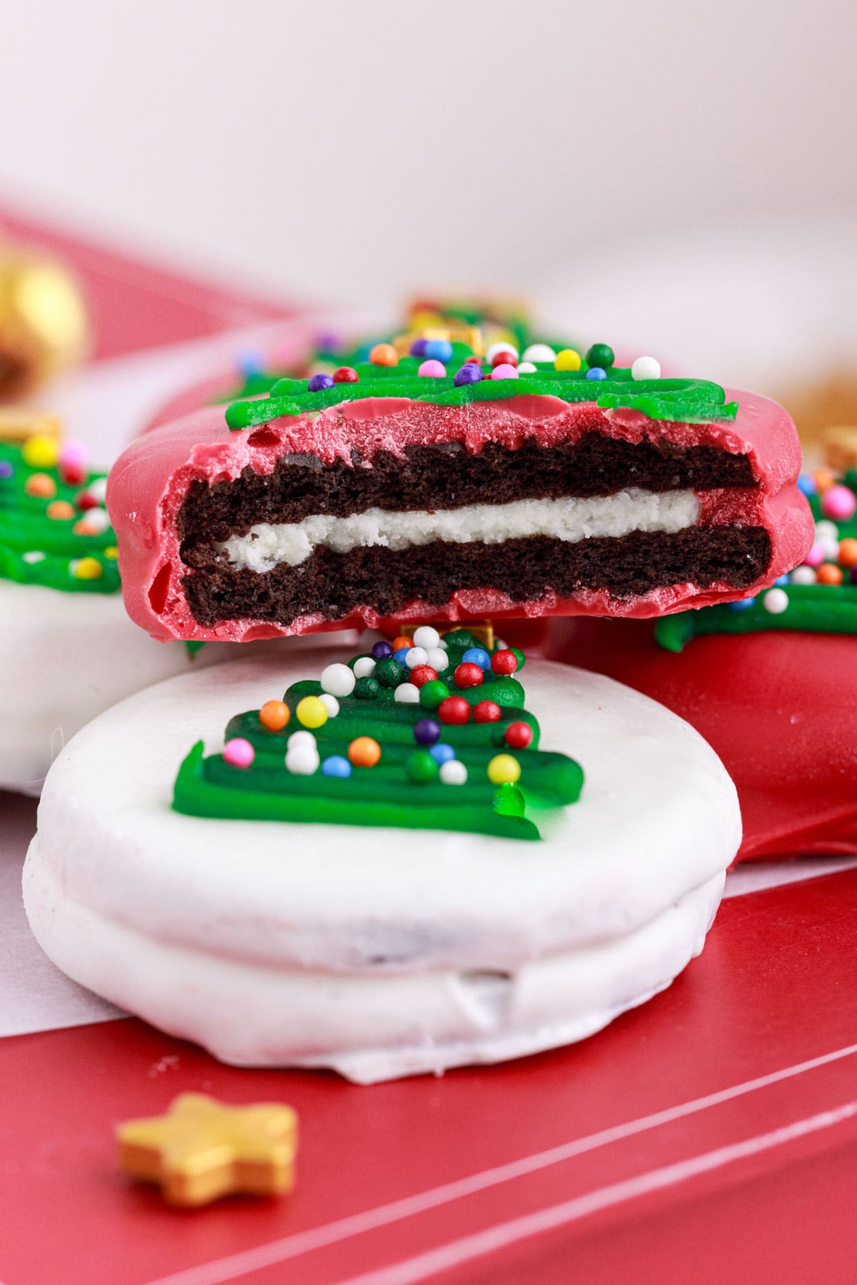 side view of dipped oreo christmas tree cookies, one with a bite missing