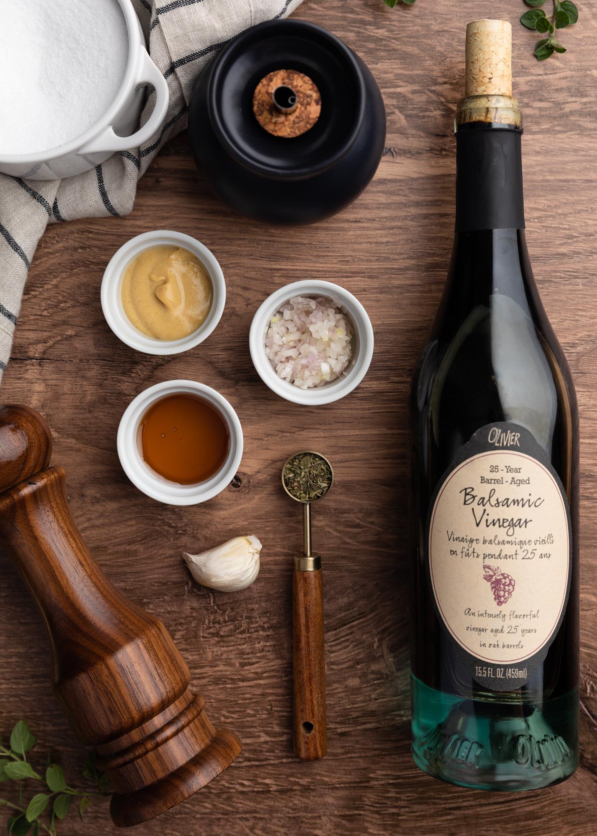 overhead photo showing a bottle of balsamic vinegar and the ingredients for vinaigrette in pinch cups