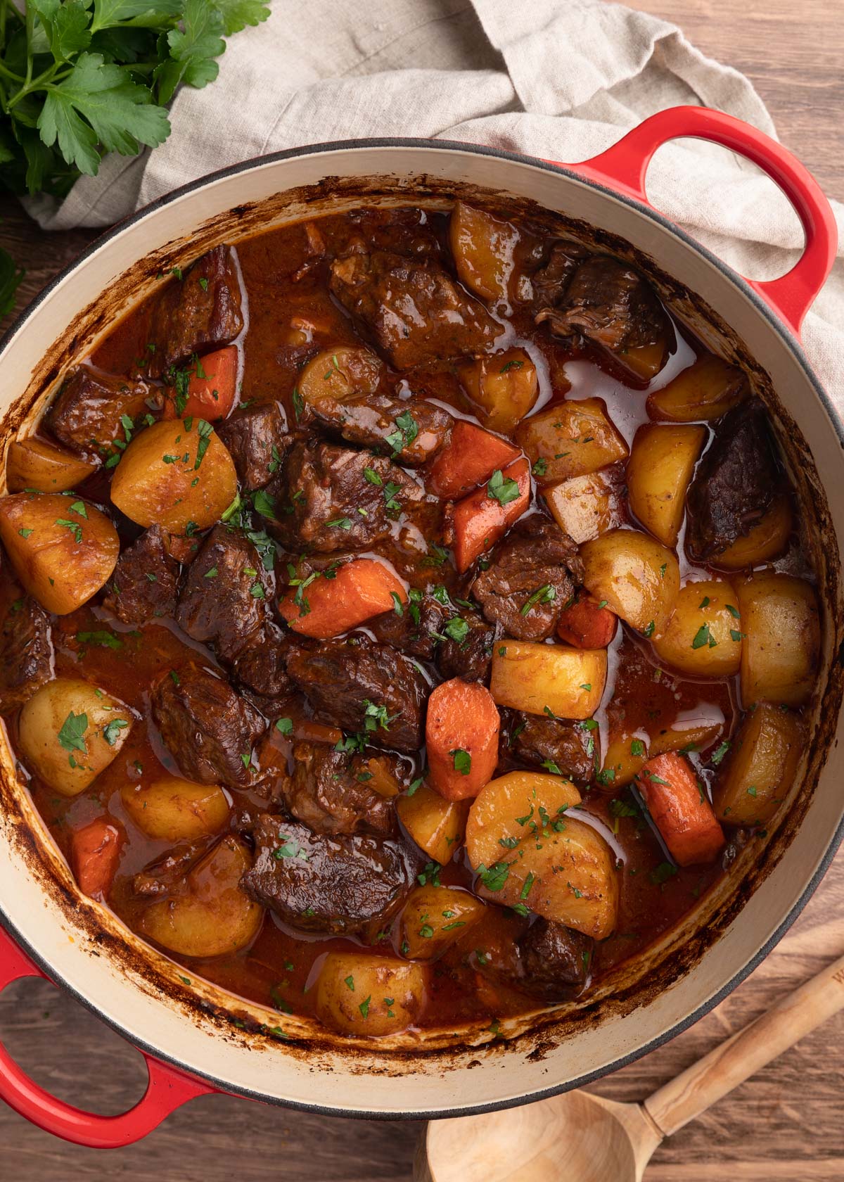 overhead photo of cooked Guinness Beef Stew with potatoes and carrots in a Dutch oven