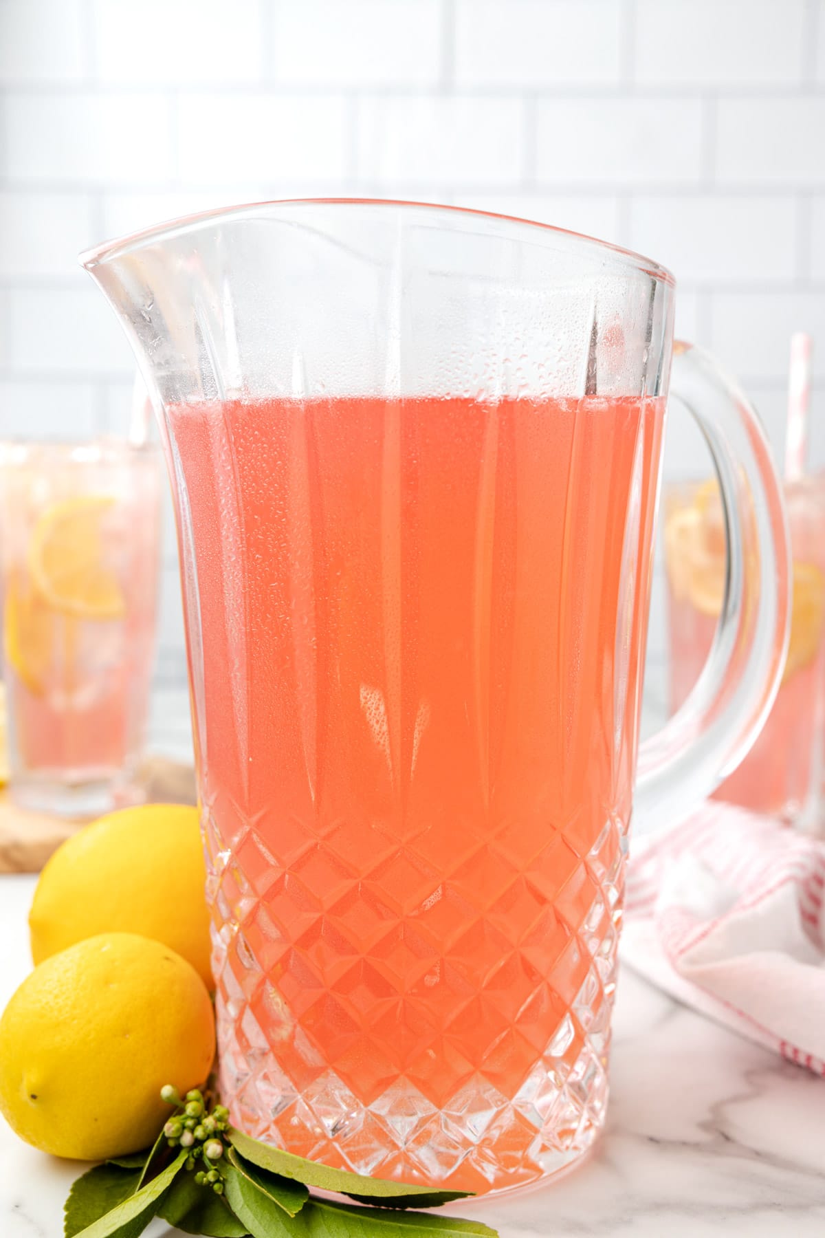 glass pitcher filled with pink lemonade