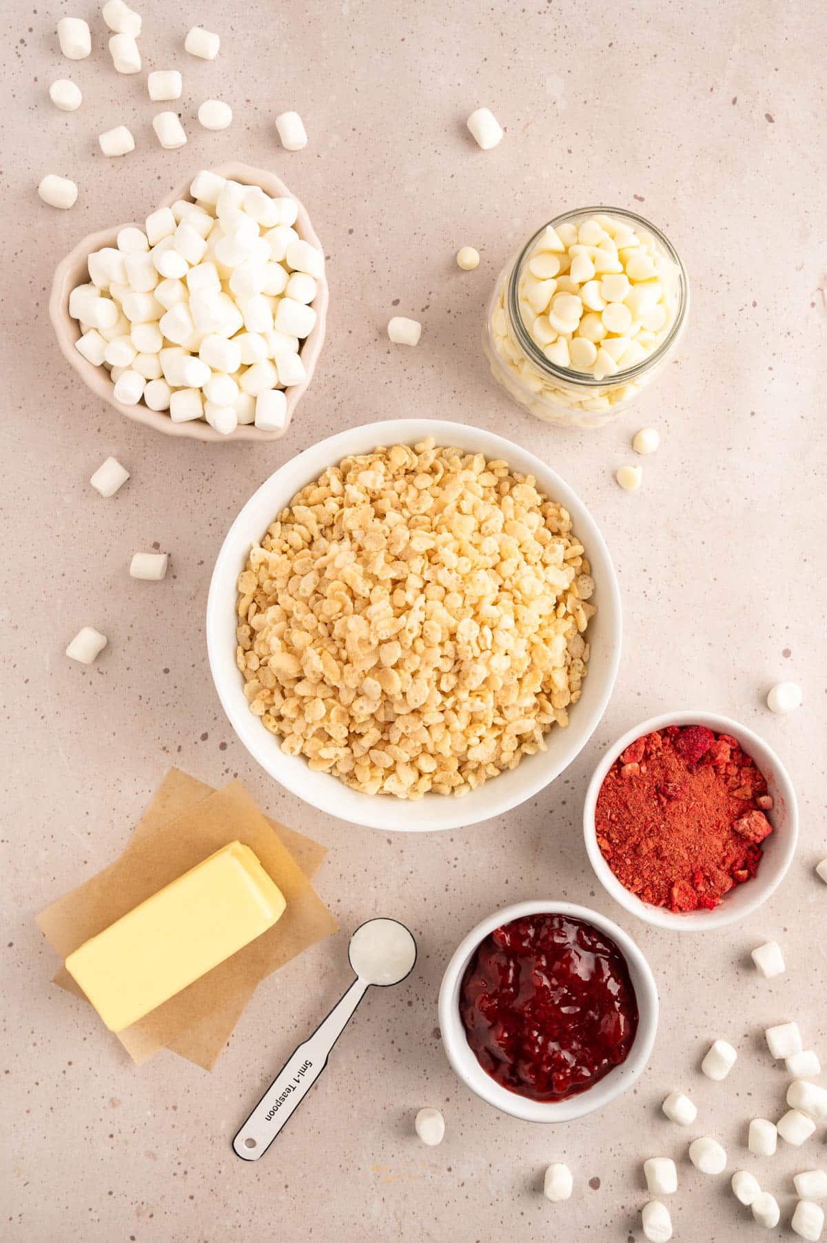 overhead photo of ingredients needed to make strawberry rice krispie treats in bowls