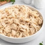 shredded chicken seasoned with black pepper in a white ceramic bowl