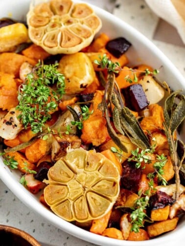 roasted root vegetables in a white casserole dish