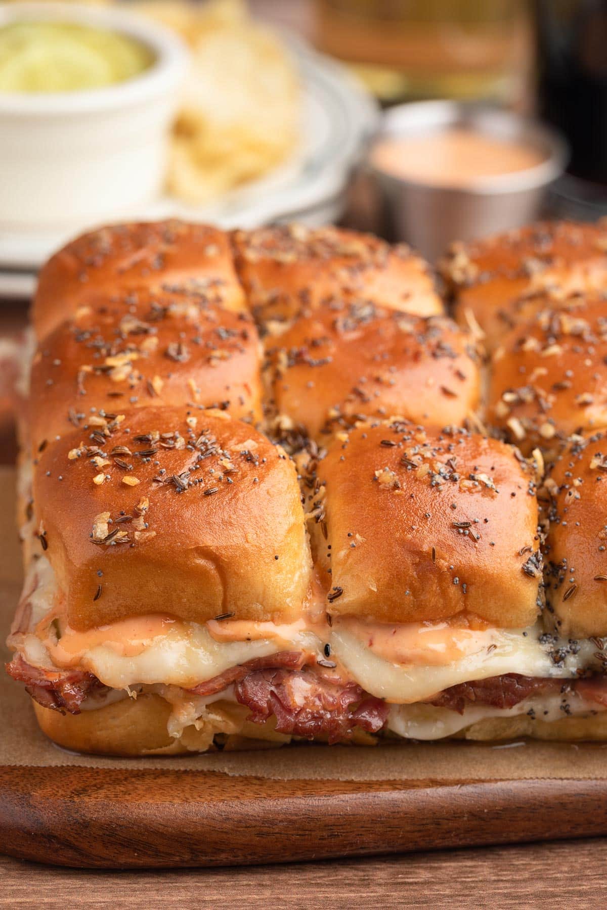 reuben sliders on a parchment-lined wooden board