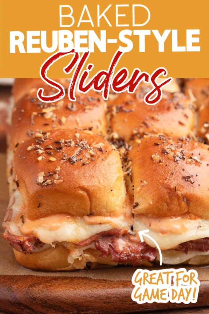 closeup of baked reuben sliders on a wood board with text overlays that read "baked reuben-style sliders" and "Great for game day!"