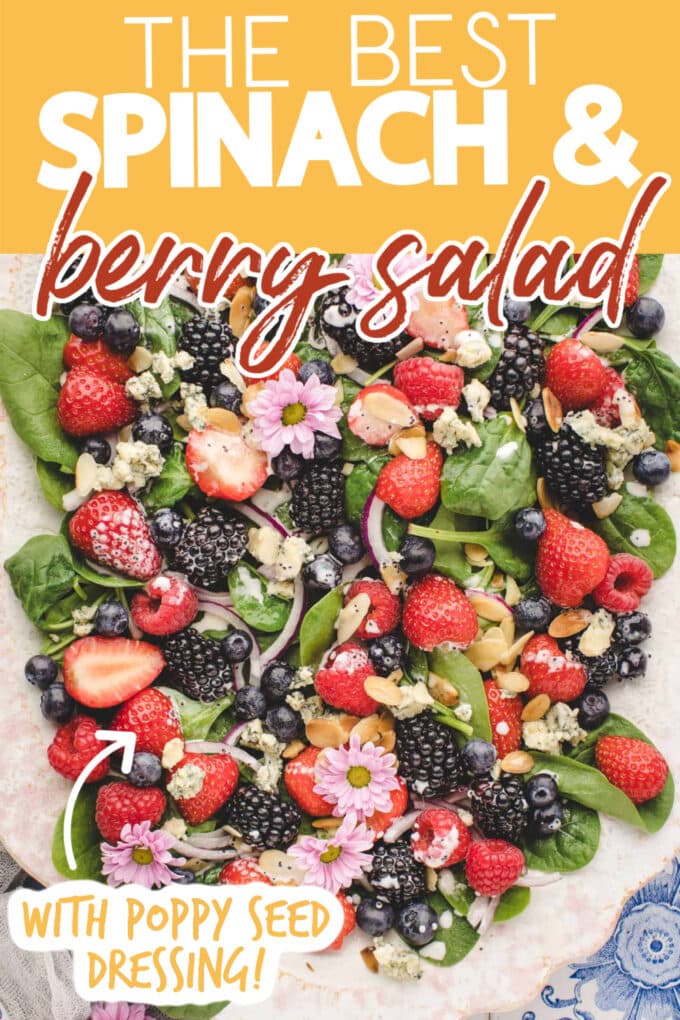 spinach berry salad on a platter. text reads "the best spinach & berry salad" and "with poppy seed dressing!"