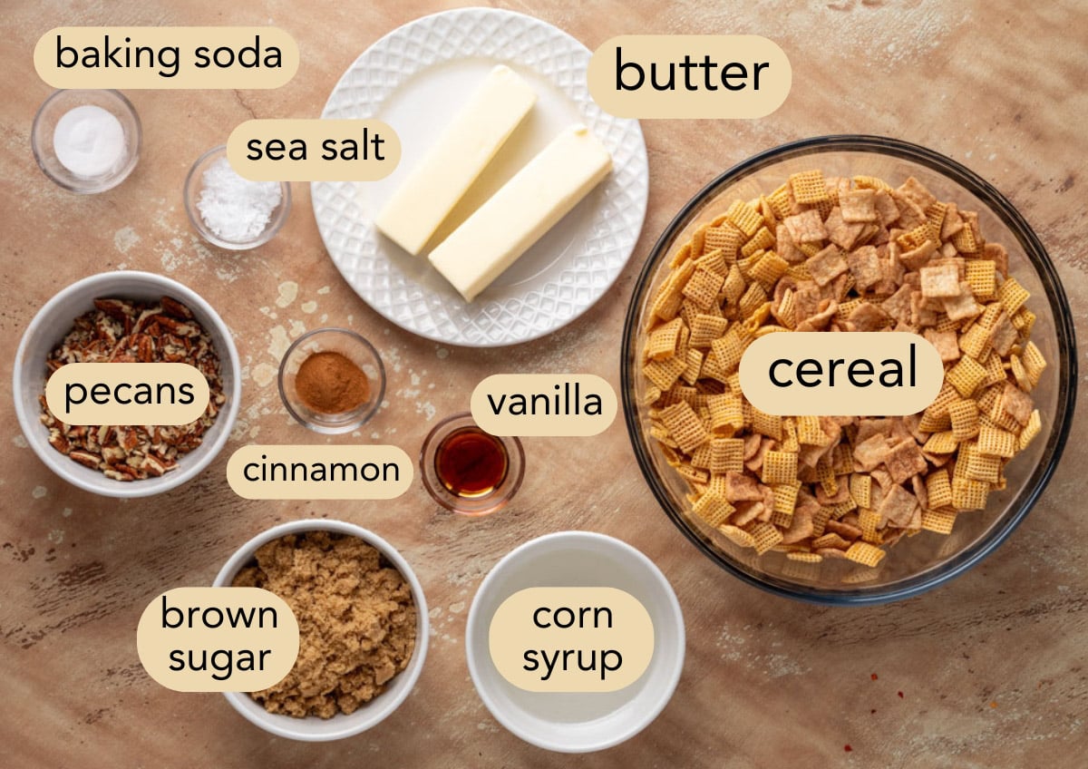 overhead of ingredients needed to make cinnamon praline crunch snack mix in bowls with text label overlays