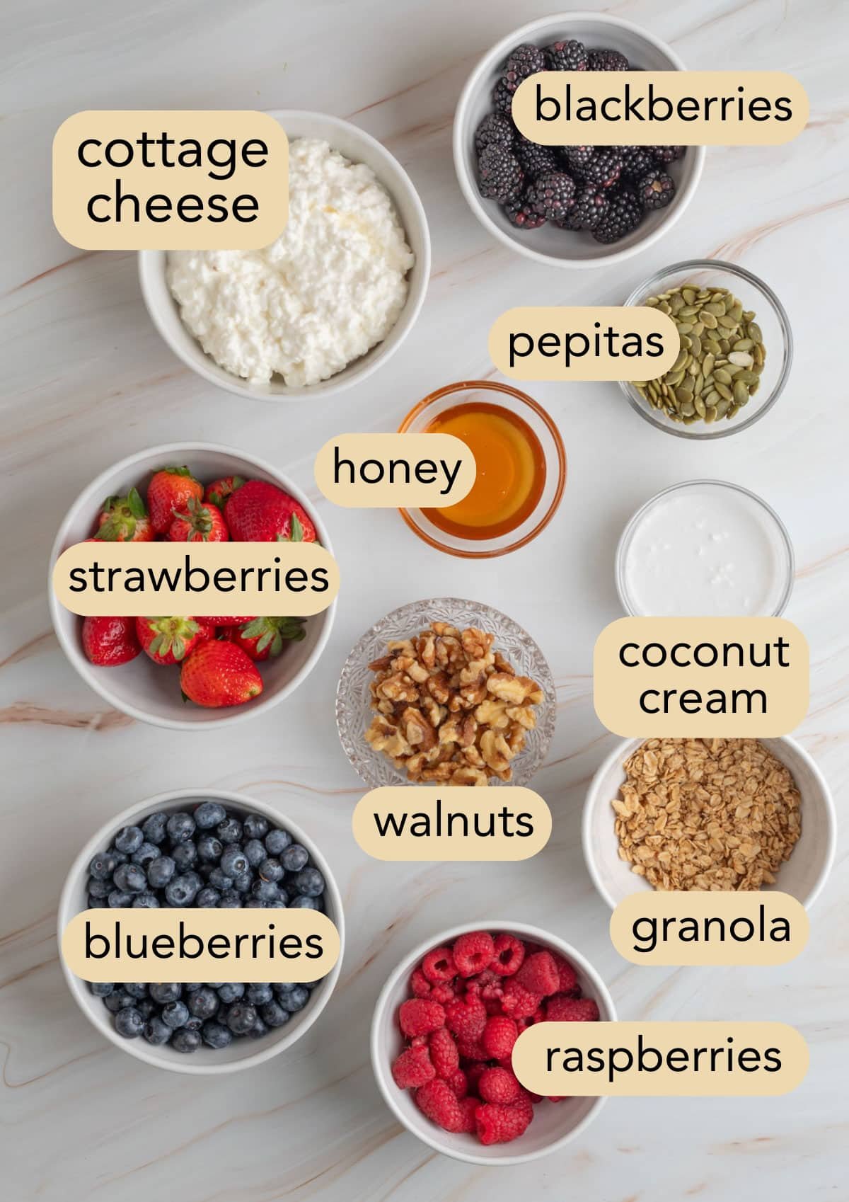 overhead of ingredients needed to make berry blended cottage cheese bowls with text label overlays