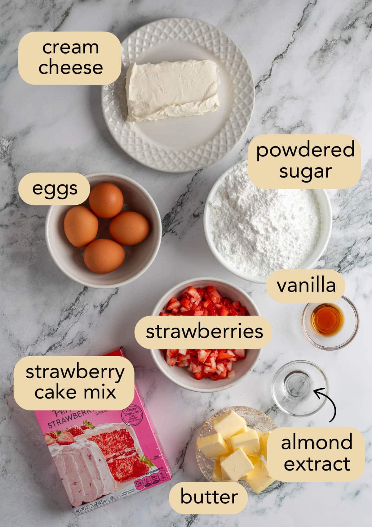 overhead of ingredients needed to make strawberry chess bars in bowls on a white marble surface with text label overlays