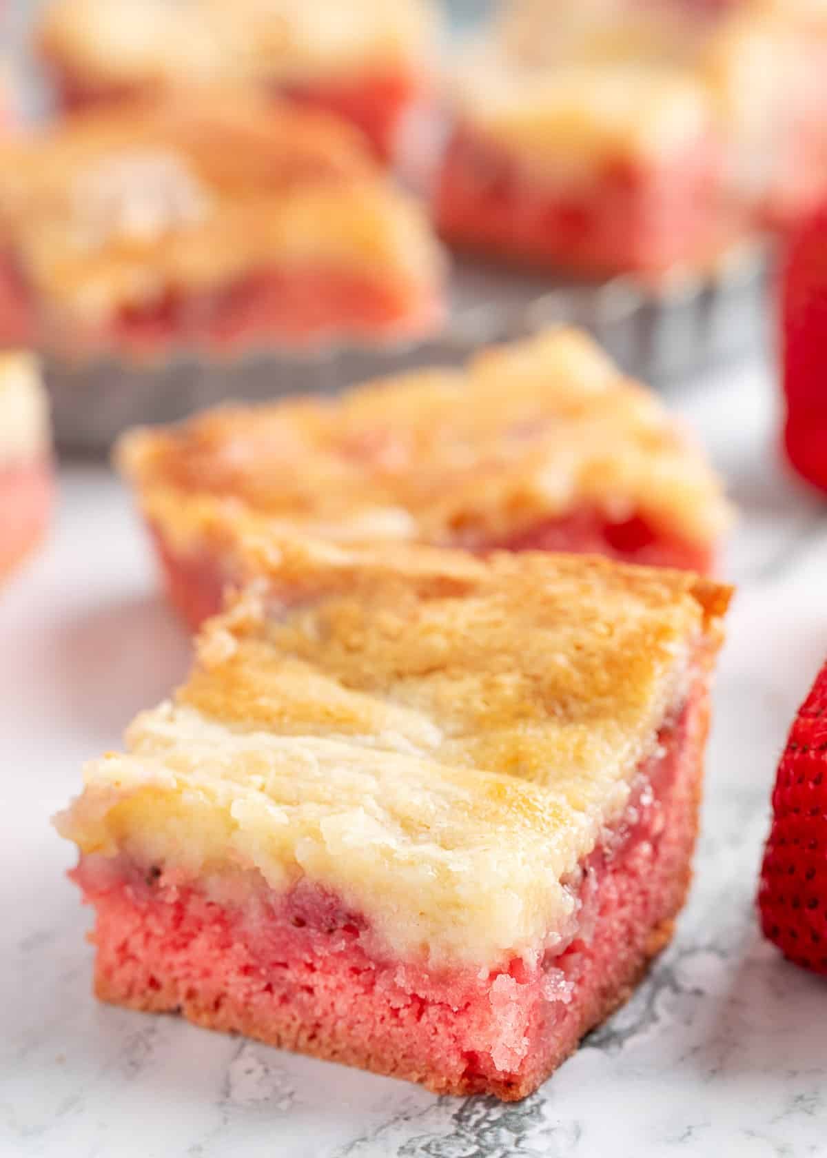 strawberry chess squares on a white marble surface
