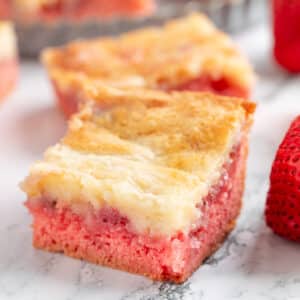 strawberry chess squares on a white marble surface