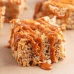 caramel drizzled apple pie rice krispies treats on parchment paper
